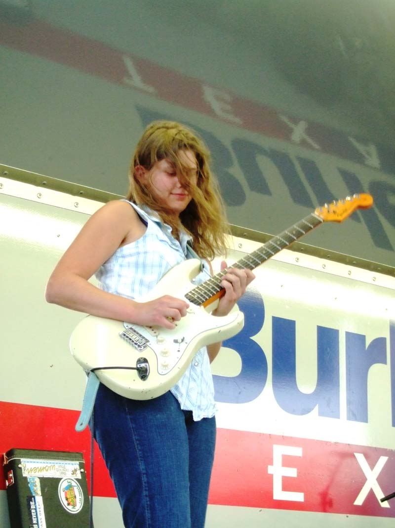 Photo of band member playing the guitar